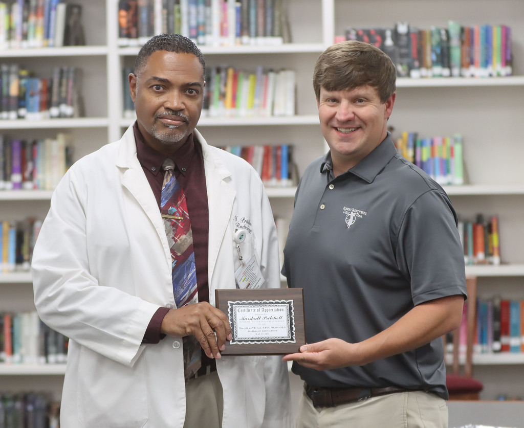 Marshall Pritchett (left), who is retiring from the Thomasville City Board of Education, was recognized for his 20 years of service May 23 at the school board meeting in the Thomasville High School library. He is pictured with Jim Davis, school board president.